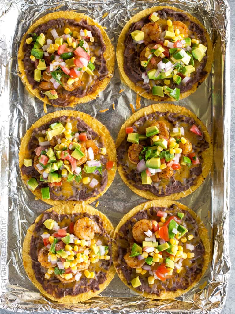 Shrimp Tostadas with black beans, avocado, onions, tomatoes, and cilantro. the-girl-who-ate-everything.com