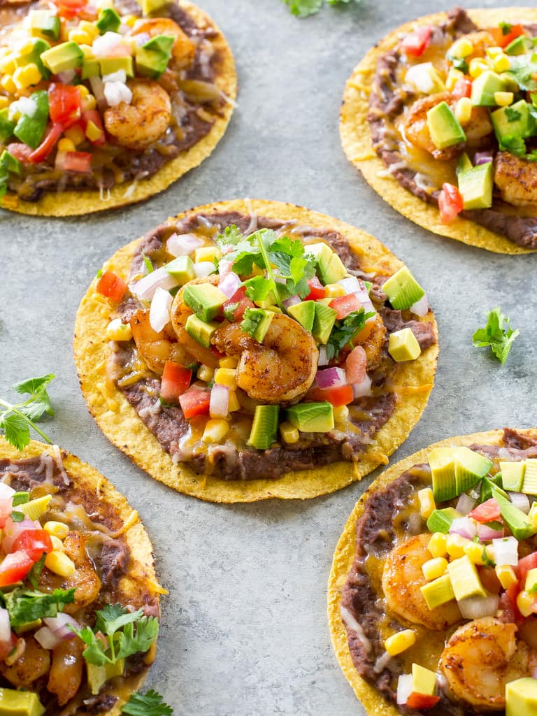Shrimp Tostadas with black beans, avocado, onions, tomatoes, and cilantro. the-girl-who-ate-everything.com