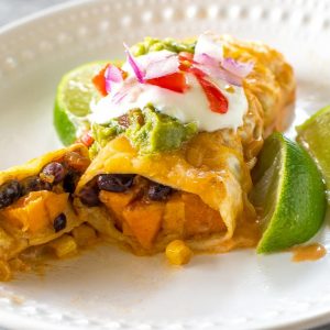 Sweet Potato and Black Bean Enchiladas - a vegetarian Mexican dinner that has the perfect amount of spice and flavor. This is a great freezer meal! the-girl-who-ate-everything.com