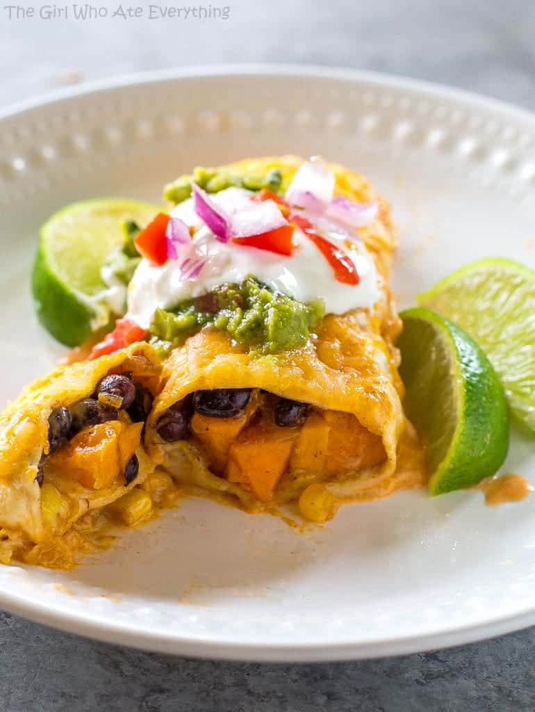 Sweet Potato and Black Bean Enchiladas - a vegetarian Mexican dinner that has the perfect amount of spice and flavor. This is a great freezer meal! the-girl-who-ate-everything.com
