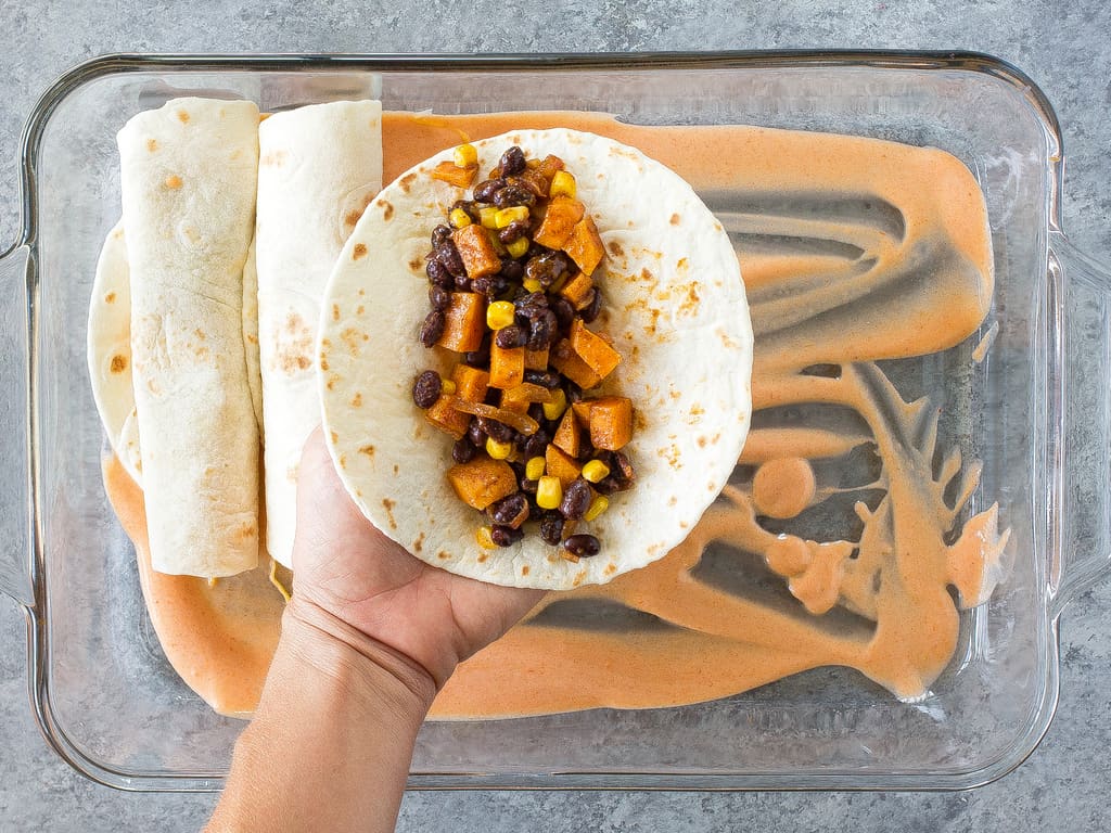 Sweet Potato and Black Bean Enchiladas - a vegetarian Mexican dinner that has the perfect amount of spice and flavor. This is a great freezer meal! the-girl-who-ate-everything.com