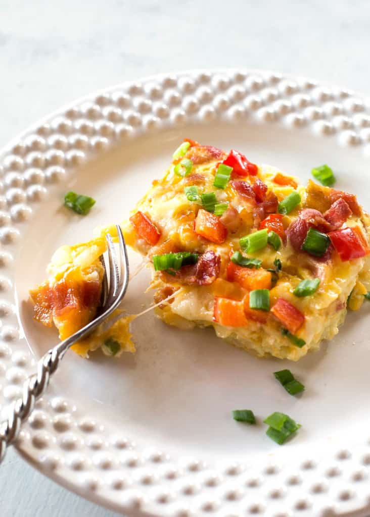 Confetti Bacon Hashbrown Casserole - a great breakfast for entertaining filled with cheesy hash browns, eggs, chiles, green onions, and red bell pepper. the-girl-who-ate-everything.com