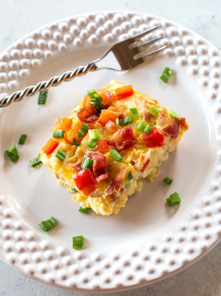 Confetti Bacon Hashbrown Casserole - a great breakfast for entertaining filled with cheesy hash browns, eggs, chiles, green onions, and red bell pepper. the-girl-who-ate-everything.com
