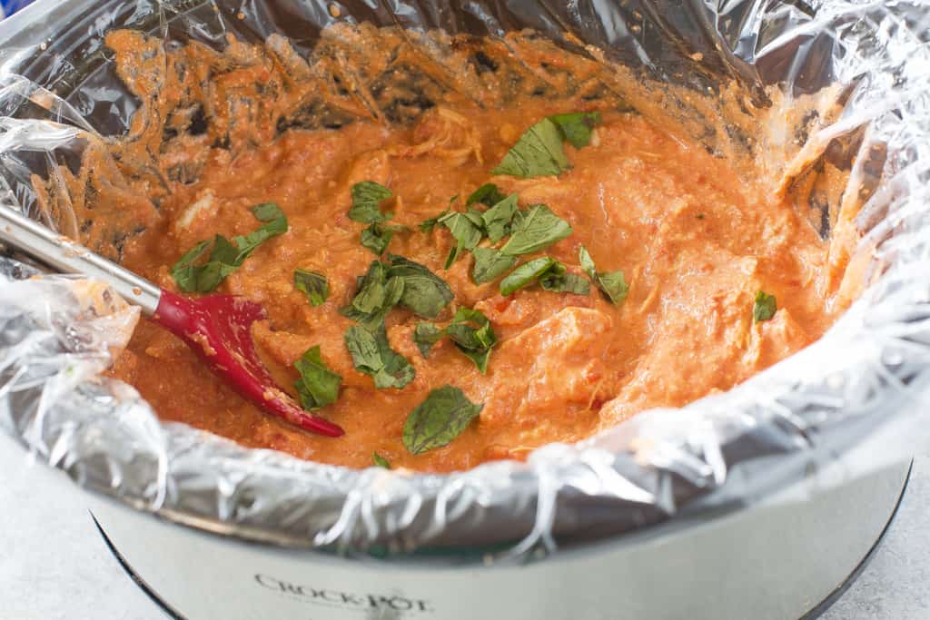 Creamy Tomato Basil Chicken - made in the slow cooker and served over pasta for an easy weeknight dinner. the-girl-who-ate-everything.com