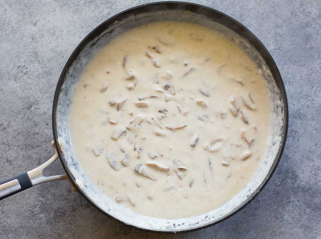 This homemade Green Bean Casserole recipe made without cream of mushroom soup. Easy and delicious side for Thanksgiving or any other holiday. the-girl-who-ate-everything.com