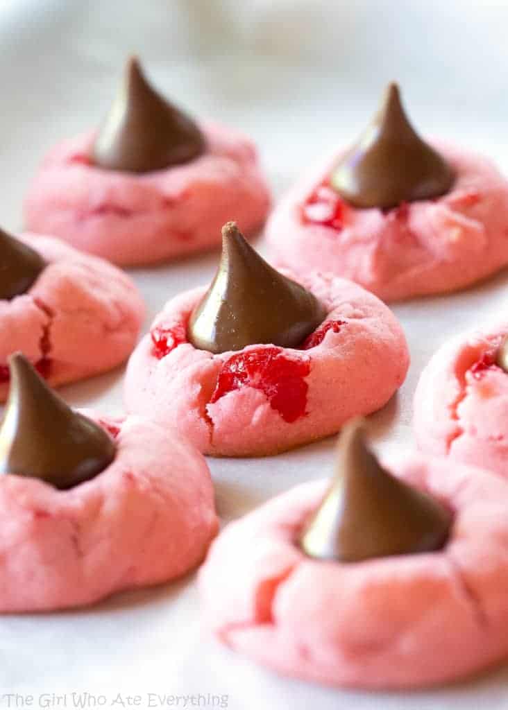 These Cherry Kiss Cookies are sweet cherry almond cookies with a chocolate Hershey kiss in the middle. Great for Christmas cookie plates.