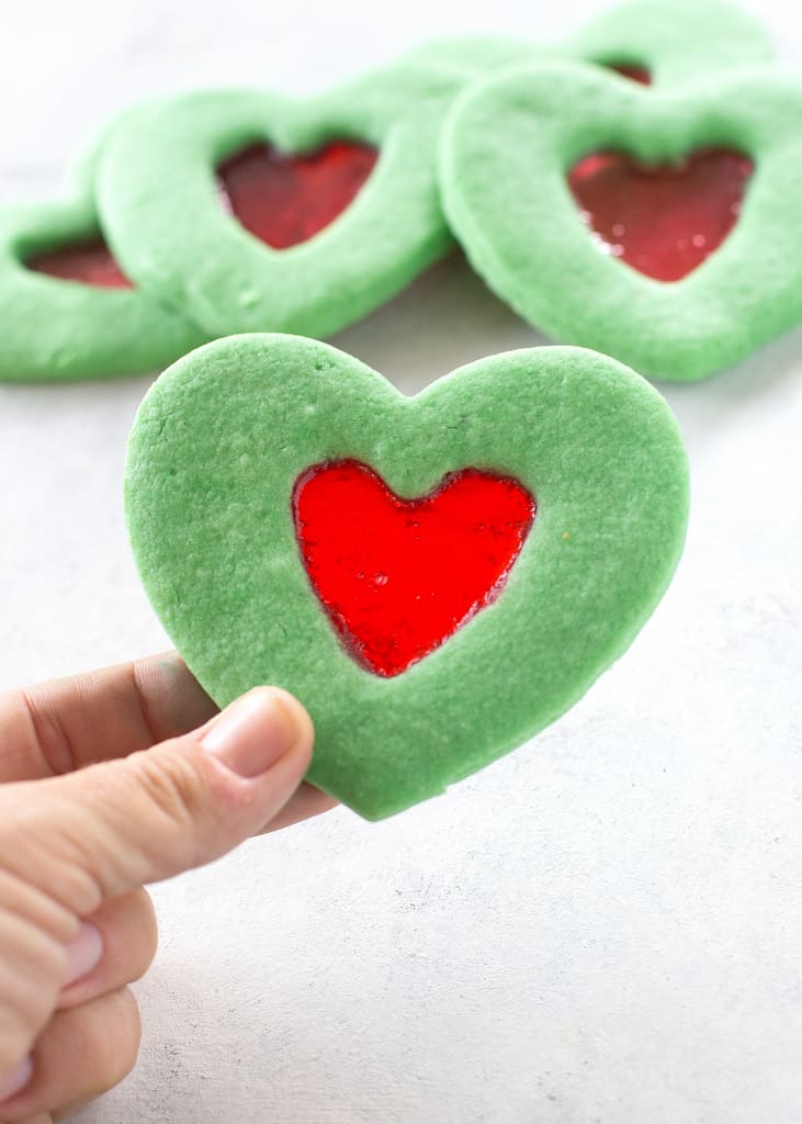These Grinch Heart Cookies are magical little treats that you can make at Christmas with your kids. the-girl-who-ate-everything.com