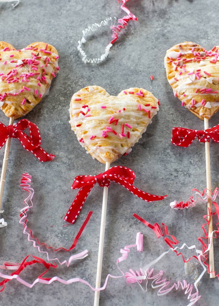 Apple Pie Pops with powdered sugar glaze and sprinkles