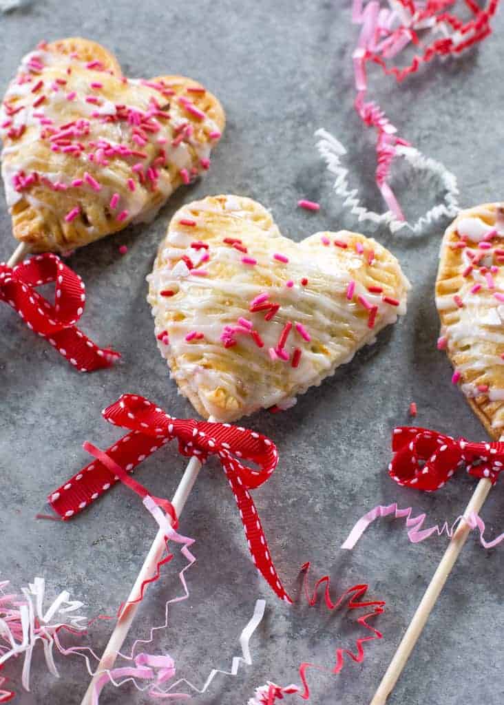 Apple Pie Pops with powdered sugar glaze and sprinkles
