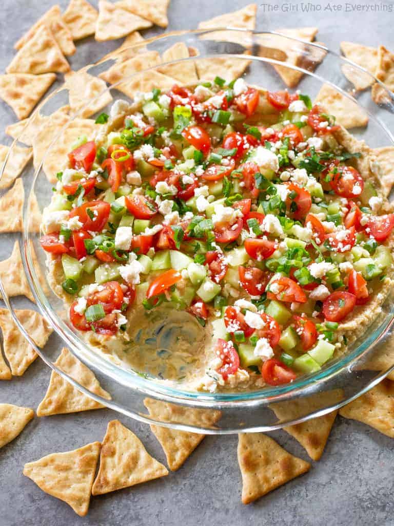 This Mediterranean 7-Layer Dip has layers of homemade tzatziki, hummus, cucumber, tomatoes, green onions, and feta..