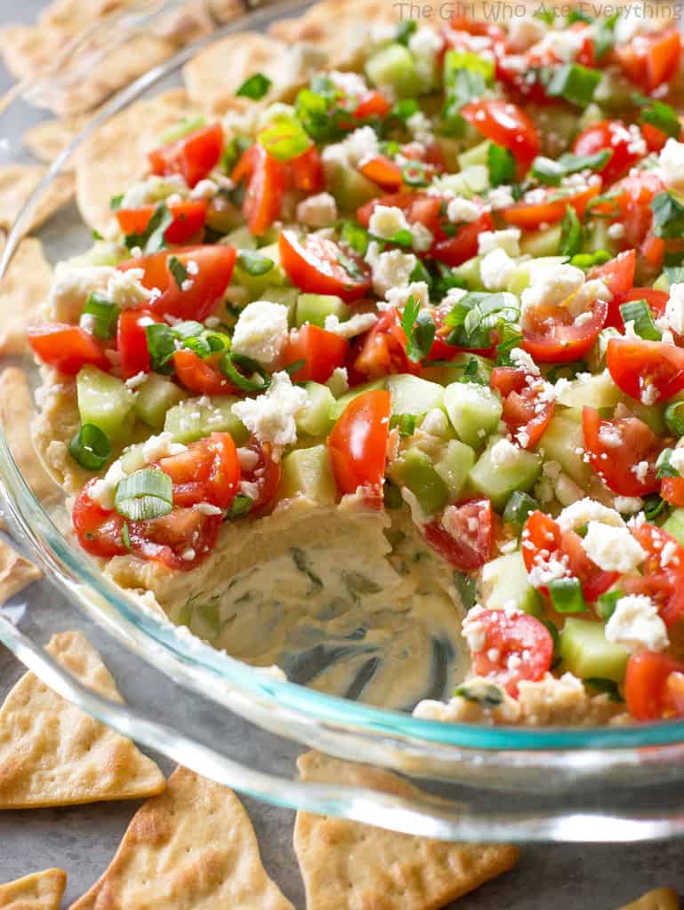 This Mediterranean 7-Layer Dip has layers of homemade tzatziki, hummus, cucumber, tomatoes, green onions, and feta..