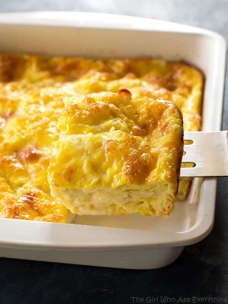 Cheesy Baked Eggs slice in a white pan 