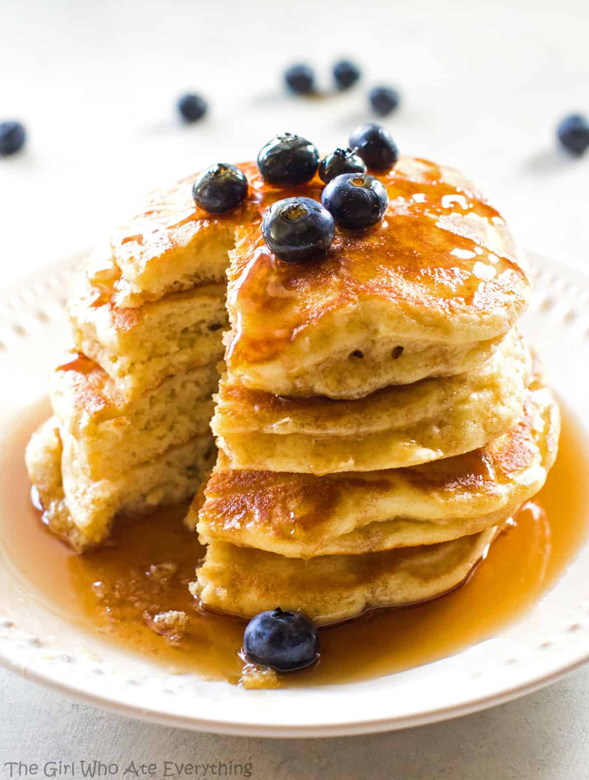 Fluffy pancakes and blueberries with syrup on a plate