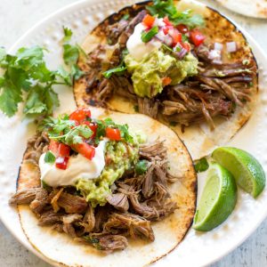 carnitas with sour cream and guacamole