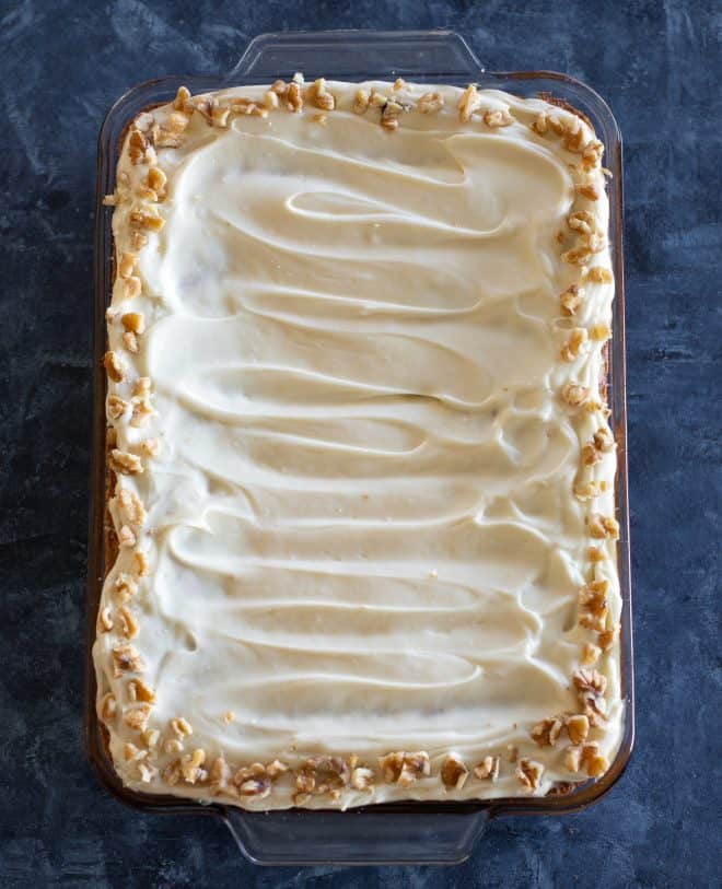 carrot cake in a baking dish with walnuts