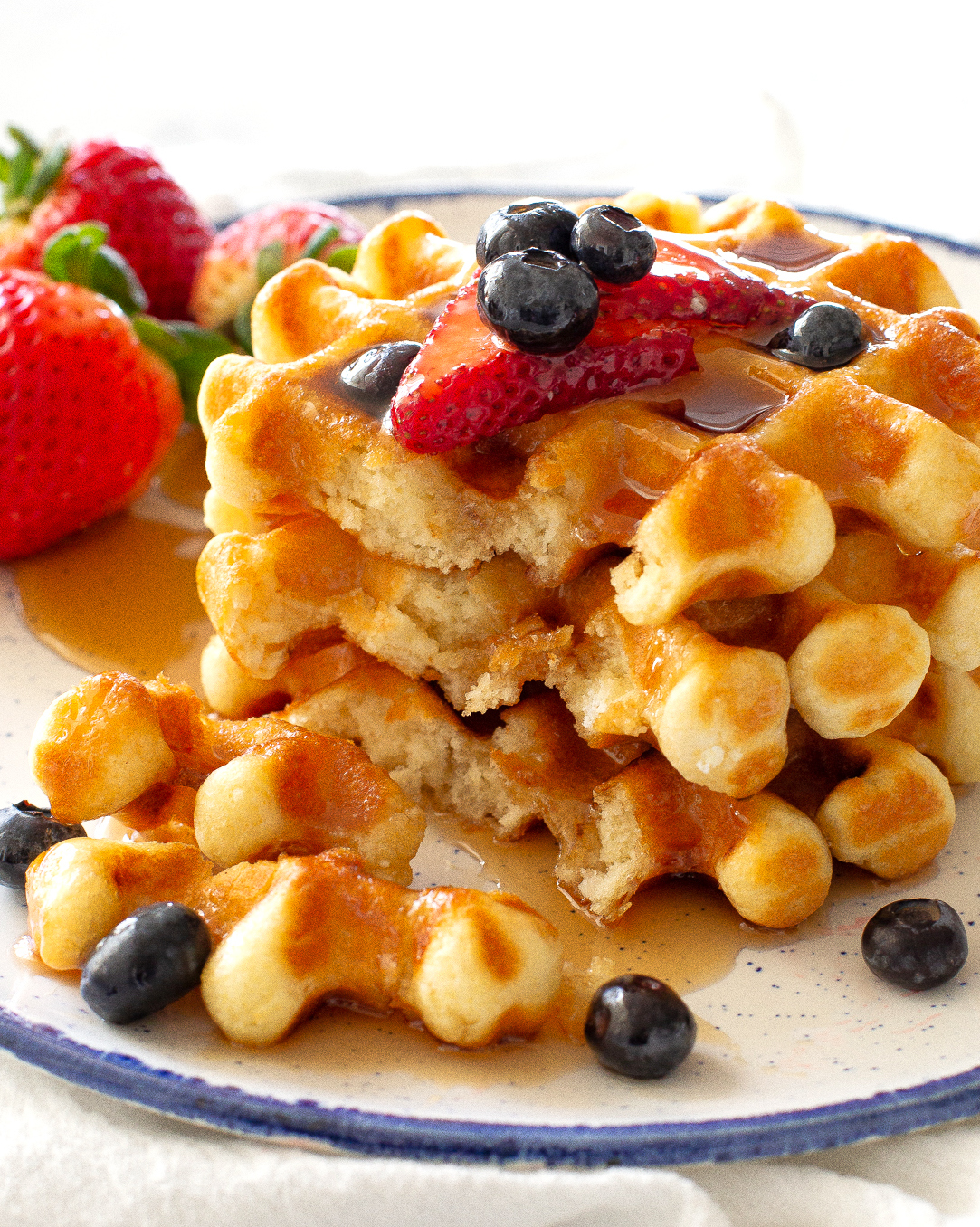 stack of waffles with strawberries and blueberries