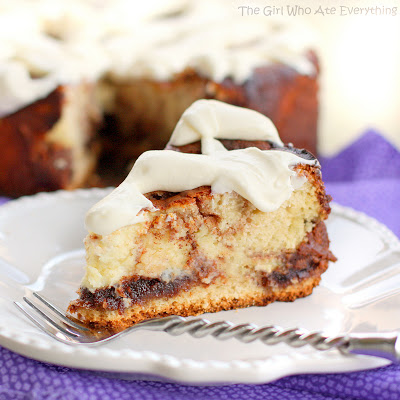 This Cinnamon Roll Cheesecake is cheesecake with cinnamon roll dough base and buttery cinnamon swirled throughout. The top is frosted with thick cream cheese frosting. the-girl-who-ate-everything.com