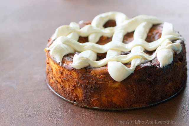 This Cinnamon Roll Cheesecake is cheesecake with cinnamon roll dough base and buttery cinnamon swirled throughout. The top is frosted with thick cream cheese frosting. the-girl-who-ate-everything.com