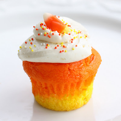 Candy Corn Cupcakes - a doctored cake mix makes these super moist candy corn colored cupcakes. Great for Halloween. the-girl-who-ate-everything.com