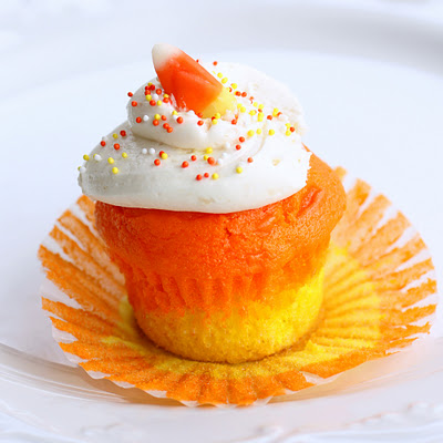 Candy Corn Cupcakes - a doctored cake mix makes these super moist candy corn colored cupcakes. Great for Halloween. the-girl-who-ate-everything.com
